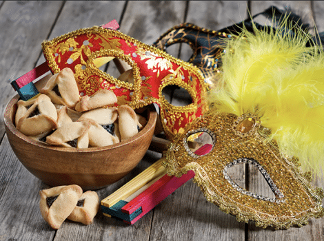 bowl of hamantashen and purim mask