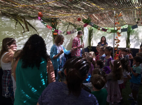 people standing in a sukkah