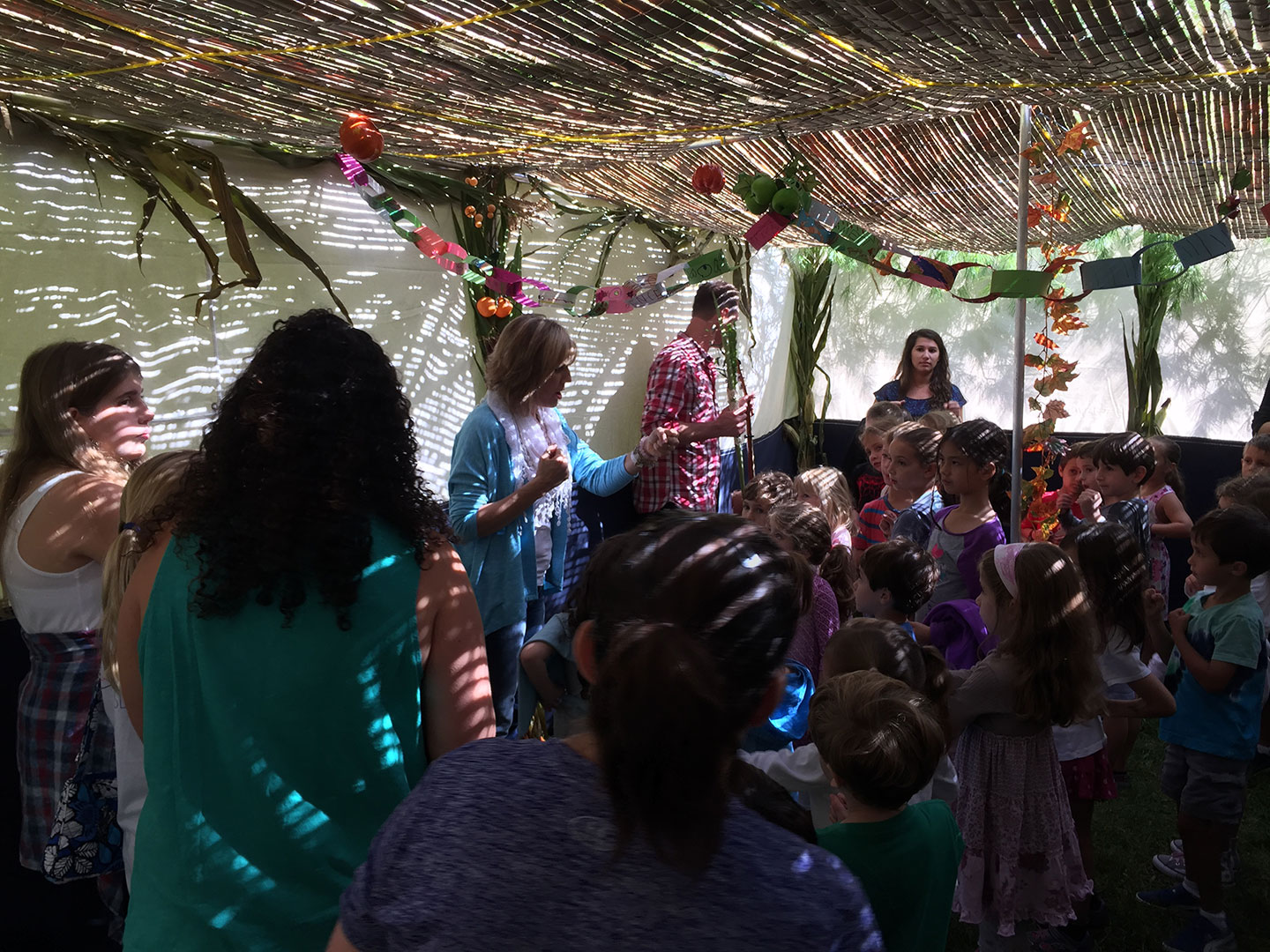 people standing in a sukkah