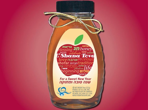 Jar of honey on red background
