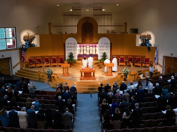 Clergy face the ark on the bima during Yom Kippur in the Sanctuary