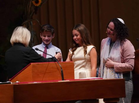 two teens on the bima receiving their kiddush cup