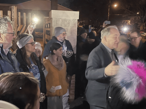 crowd gathers for a rally and Hanukkah candle lighting ceremony