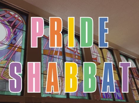 Pride Shabbat in rainbow letters over Kreeger Lobby stained glass