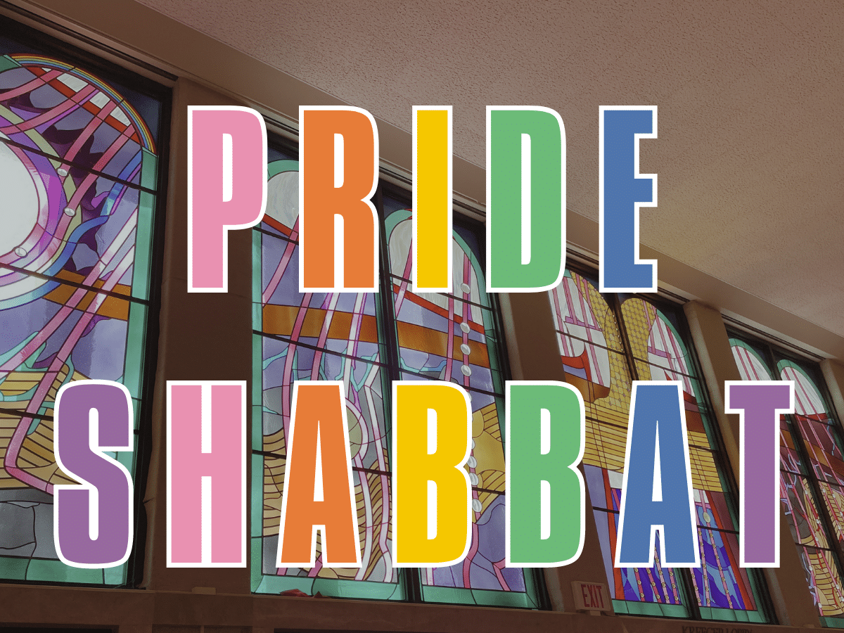 Pride Shabbat in rainbow letters over Kreeger Lobby stained glass