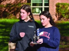 two teen girls outside holding havdalah candles