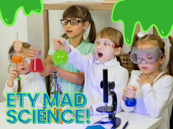 children in lab coats and safety goggles with test tubes and beakers