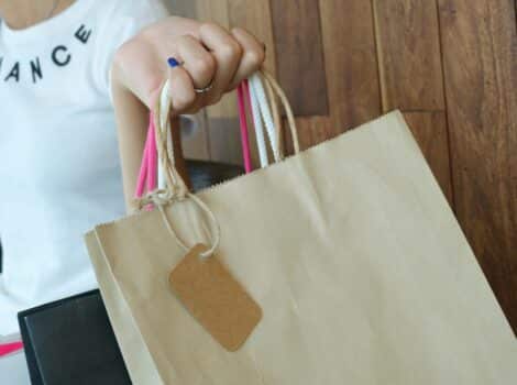 woman carries a bunch of shopping bags